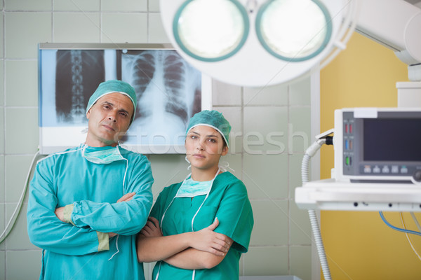 Serious surgeon and a nurse looking at camera in operating theater Stock photo © wavebreak_media