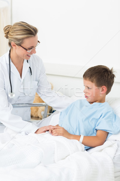 Stock photo: Doctor comforting sick boy in hospital