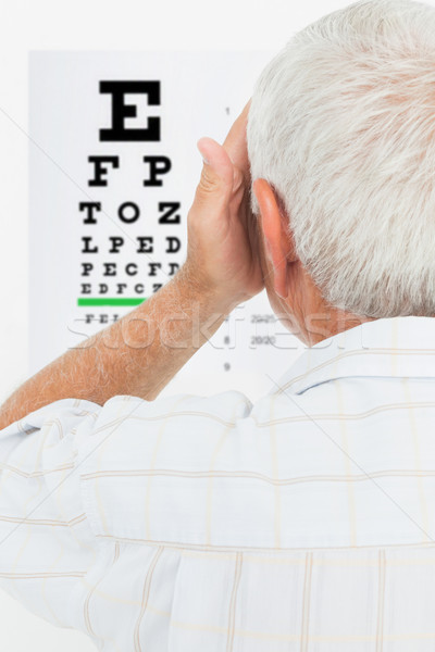 Rear view of a senior man looking at eye chart Stock photo © wavebreak_media