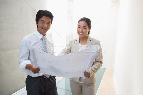 Agent immobilier regarder plan potentiel acheteur couloir [[stock_photo]] © wavebreak_media