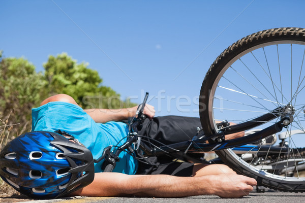 Cyclist lying on the road after an accident Stock photo © wavebreak_media