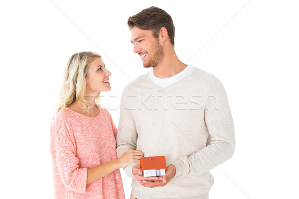 Attractive couple holding miniature house model Stock photo © wavebreak_media