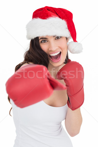 Festive brunette in boxing gloves punching Stock photo © wavebreak_media