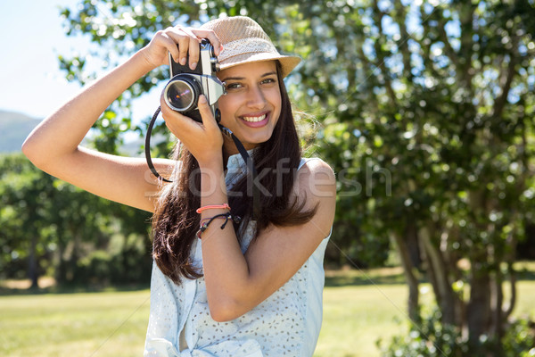 Pretty brunette using retro camera Stock photo © wavebreak_media