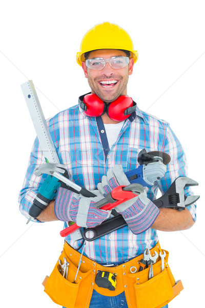 Portrait of smiling manual worker holding various tools Stock photo © wavebreak_media