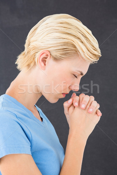 Pretty blond woman praying Stock photo © wavebreak_media