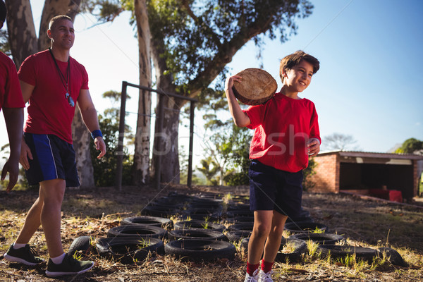 Trainer instructing a boy during obstacle course training Stock photo © wavebreak_media