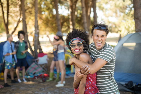 Portrait of cheerful friends embracing at campsite Stock photo © wavebreak_media