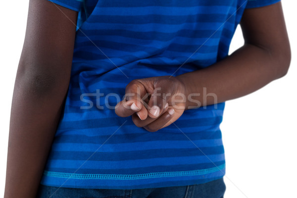 Mid-section of boy holding his fingers crossed Stock photo © wavebreak_media
