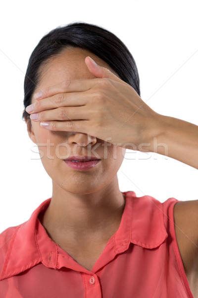 Woman covering her eyes with hand against white background Stock photo © wavebreak_media