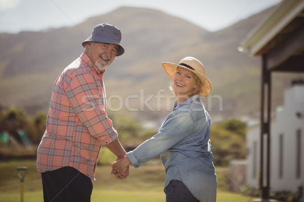 Casal de idosos de mãos dadas em pé gramado retrato Foto stock © wavebreak_media