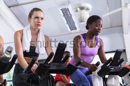 Trainer talking to athlete while relaxing in gym Stock photo © wavebreak_media