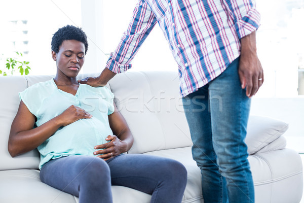 Sad pregnant woman sitting on couch Stock photo © wavebreak_media