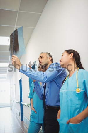 Nurse interacting with doctor while adjusting medical machine Stock photo © wavebreak_media