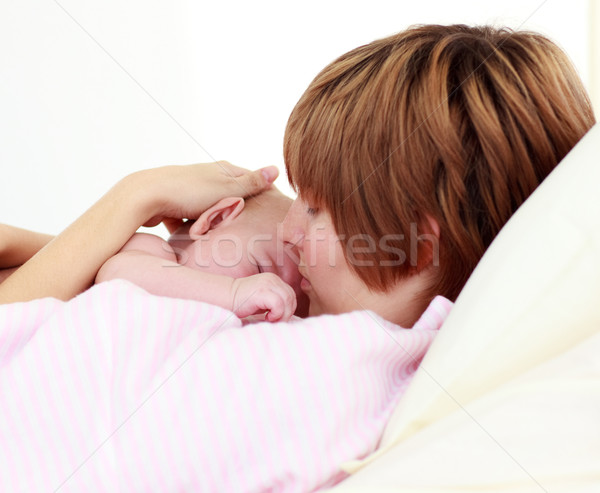 Portrait of a patient kissing her newborn baby in bed Stock photo © wavebreak_media