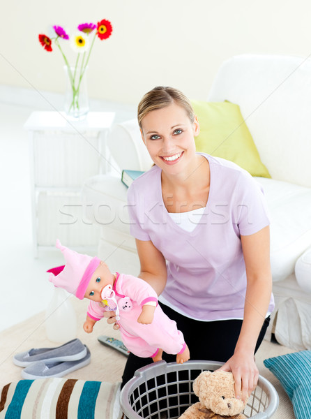 Merry young mother putting toys into a basket Stock photo © wavebreak_media