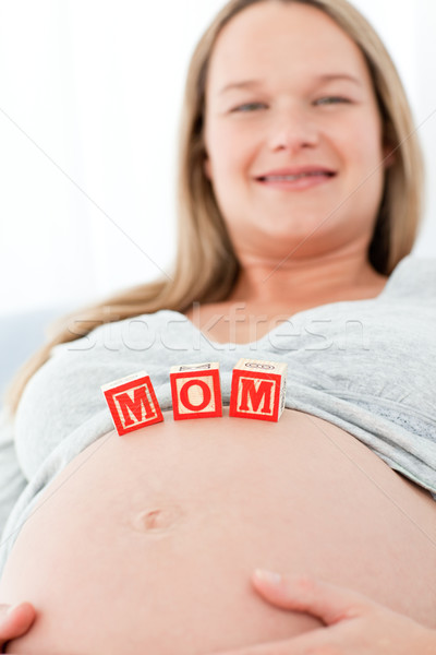 Close up of a woman having mom letters on her belly lying on a bed at home Stock photo © wavebreak_media