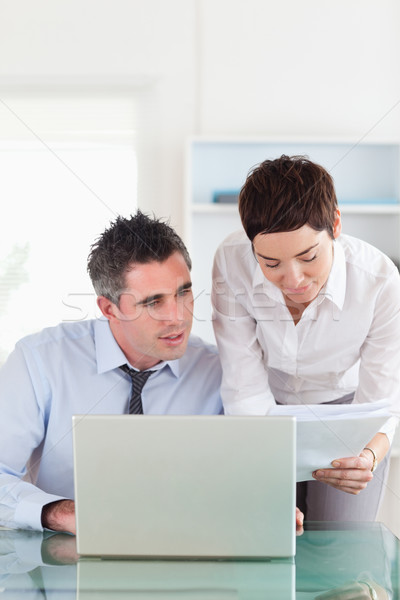 Stock photo: Portrait of colleagues comparing a blueprint document to an electronic one in an office