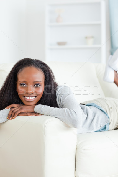 Smiling woman taking a moment off on sofa Stock photo © wavebreak_media