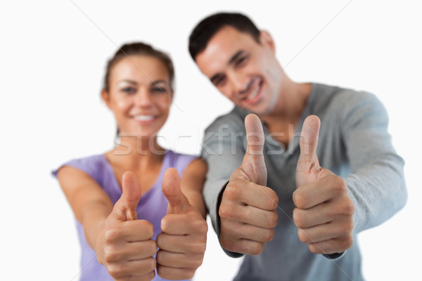 Approval being given by young couple against a white background Stock photo © wavebreak_media