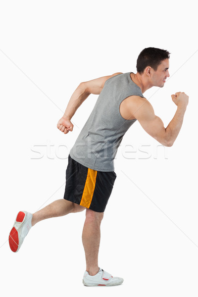 Stock photo: Young man warming up before training against a white background