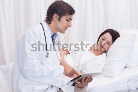Stock photo: Young doctor got good news for his patient