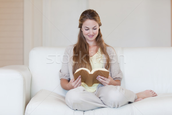 Young woman reading a novel on the sofa Stock photo © wavebreak_media