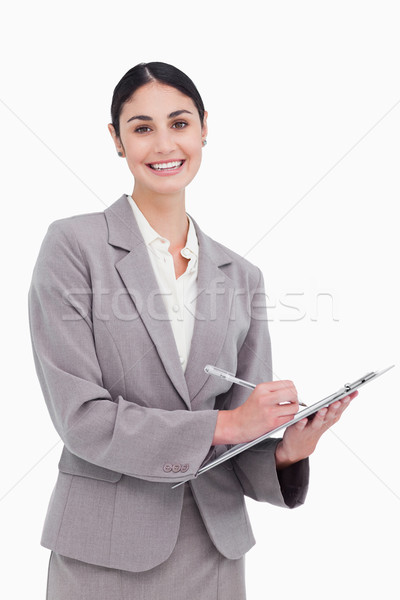 Smiling businesswoman ready to take notes against a white background Stock photo © wavebreak_media