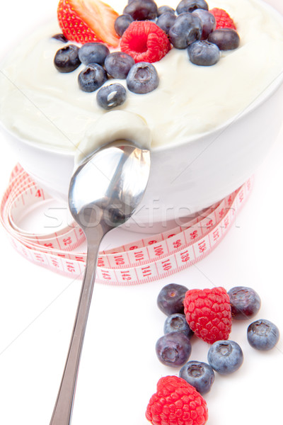 Berries cream and spoon with a tape measure  against a white background Stock photo © wavebreak_media
