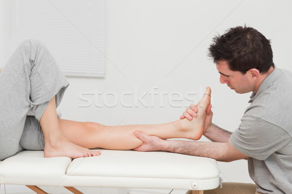 Calf of a patient being massaged by a physiotherapist in a room Stock photo © wavebreak_media