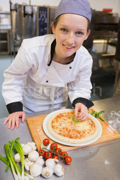 Smiling chef preparing pizza in kitchen Stock photo © wavebreak_media