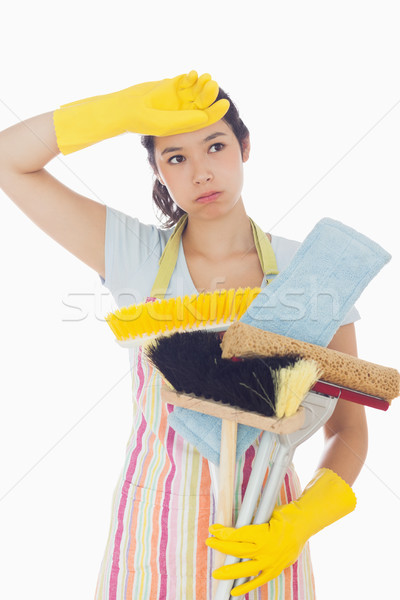 Overworked young woman holding cleaning tools Stock photo © wavebreak_media