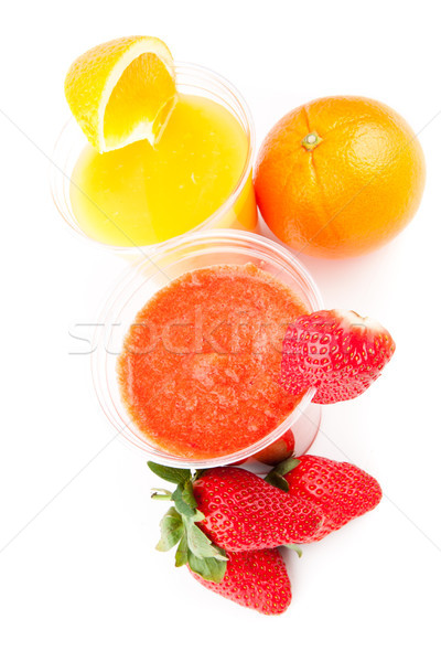 Glasses of orange and strawberry drinks on white background Stock photo © wavebreak_media