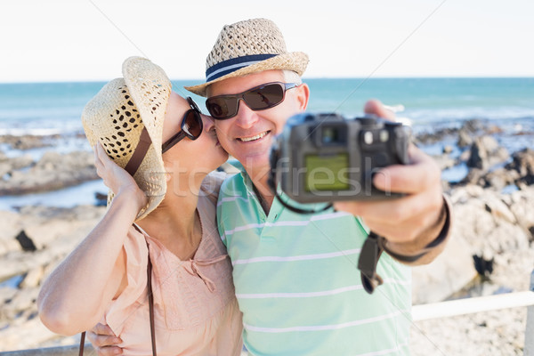 Happy casual couple taking a selfie by the coast Stock photo © wavebreak_media