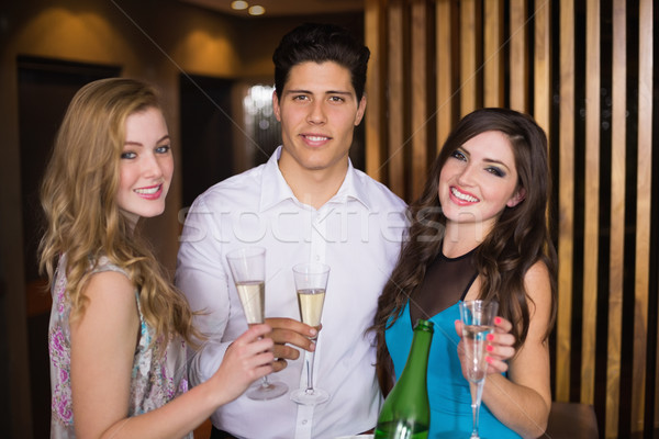 привлекательный друзей улыбаясь камеры шампанского Сток-фото © wavebreak_media