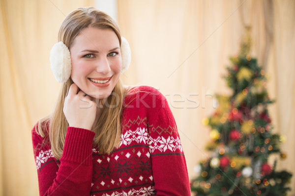 Portrait of a pretty smiling blonde wearing earmuffs Stock photo © wavebreak_media