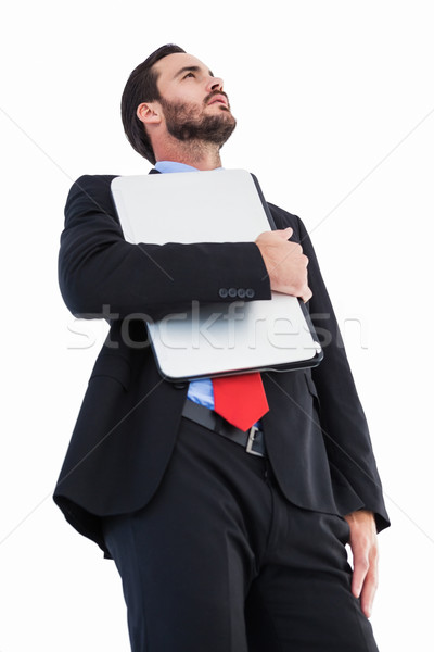 Concentrating businessman in suit holding laptop Stock photo © wavebreak_media
