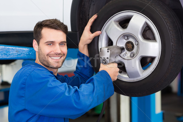 Mechanic adjusting the tire wheel Stock photo © wavebreak_media