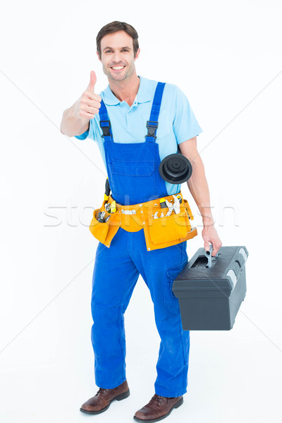 Plumber carrying tool box while gesturing thumbs up Stock photo © wavebreak_media