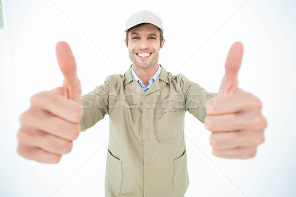 Happy delivery man showing thumbs up Stock photo © wavebreak_media