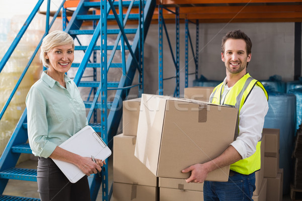 Worker holding box with manager holding clipboard Stock photo © wavebreak_media