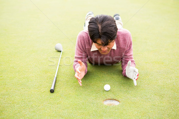 Golfer lying near golf ball  Stock photo © wavebreak_media