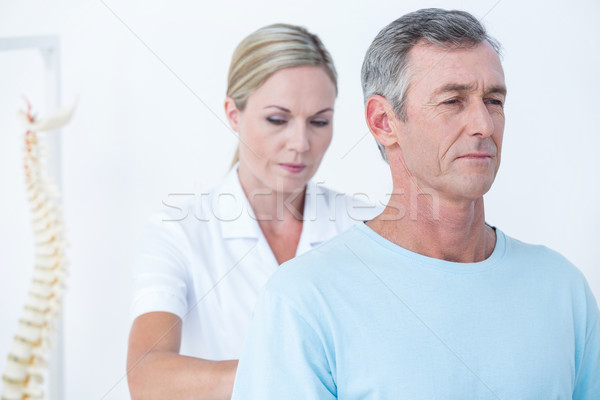 Doctor examining her patient back  Stock photo © wavebreak_media