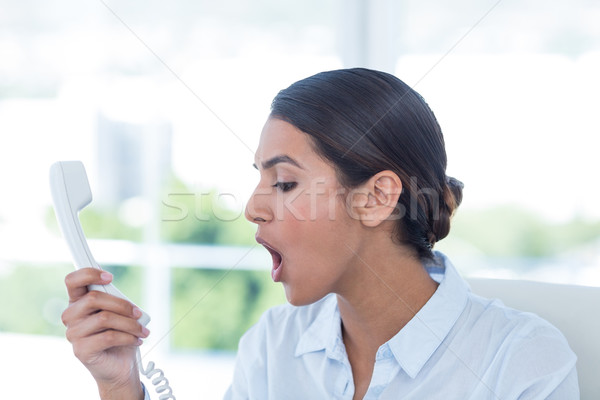 Stock photo: Businesswoman yelling at her phone