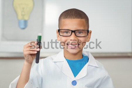 Smiling scientist showing test tube with red fluid Stock photo © wavebreak_media