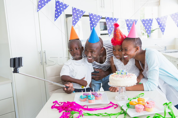 Happy family celebrating a birthday together and taking a selfie Stock photo © wavebreak_media