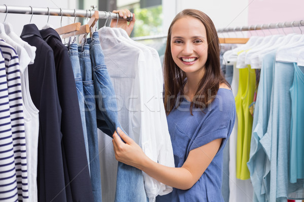 Pretty brunette browsing in the clothes rack Stock photo © wavebreak_media