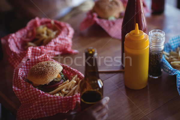 Fast food and beer bottle on table Stock photo © wavebreak_media