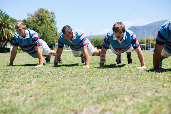 Close up of rugby players doing push up at field Stock photo © wavebreak_media