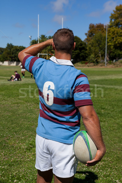 Rear view of player holding rugby ball at playing field Stock photo © wavebreak_media